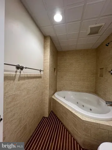 a bathroom with a bathtub and shower