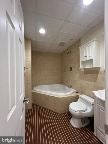 a bathroom with a toilet a sink and a mirror