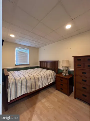 a spacious bedroom with a bed and with furniture