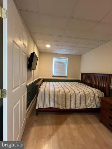 a spacious bedroom with a bed and a large window