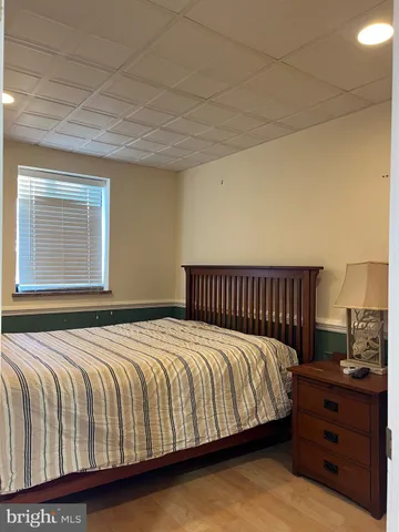 a bedroom with a bed and window