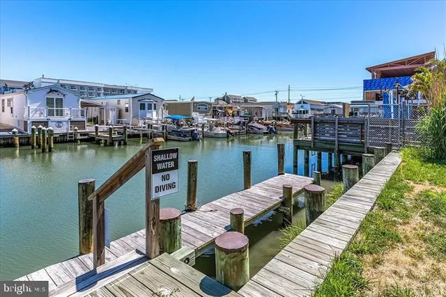 a balcony with wooden floor table and chairs