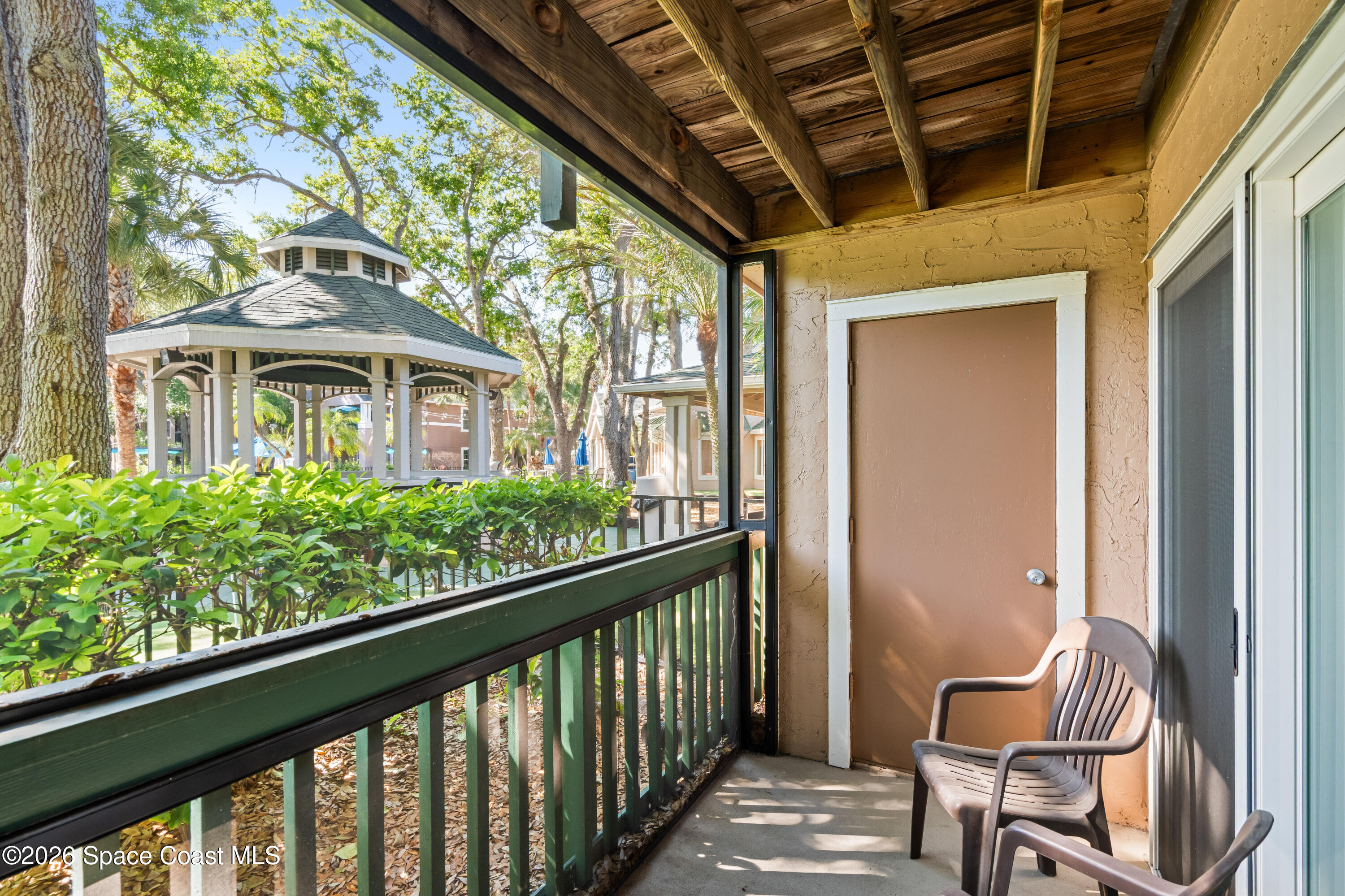7667 North Wickham Road, Unit 208 Melbourne, FL 32940 - Photo 20 of 33 a view of a chair and tables in the balcony
