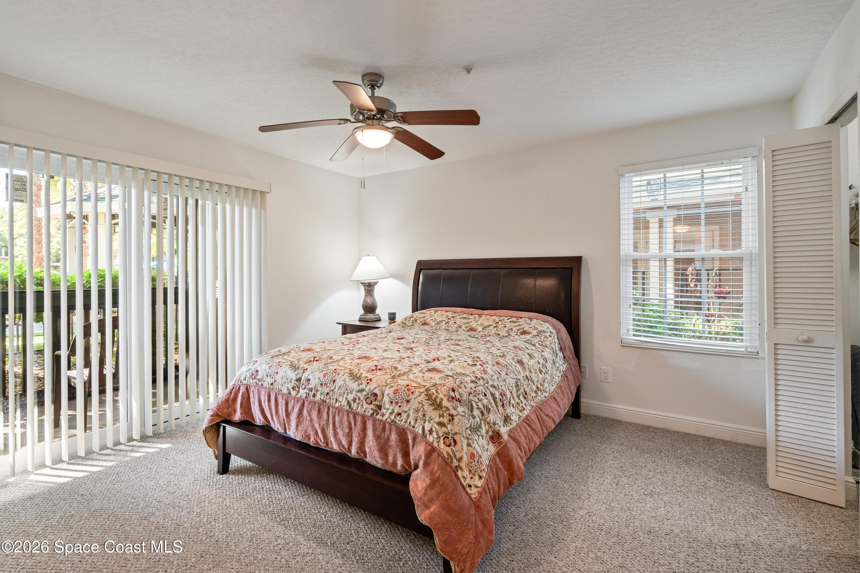 7667 North Wickham Road, Unit 208 Melbourne, FL 32940 - Photo 2 of 33 a bedroom with a bed and a window