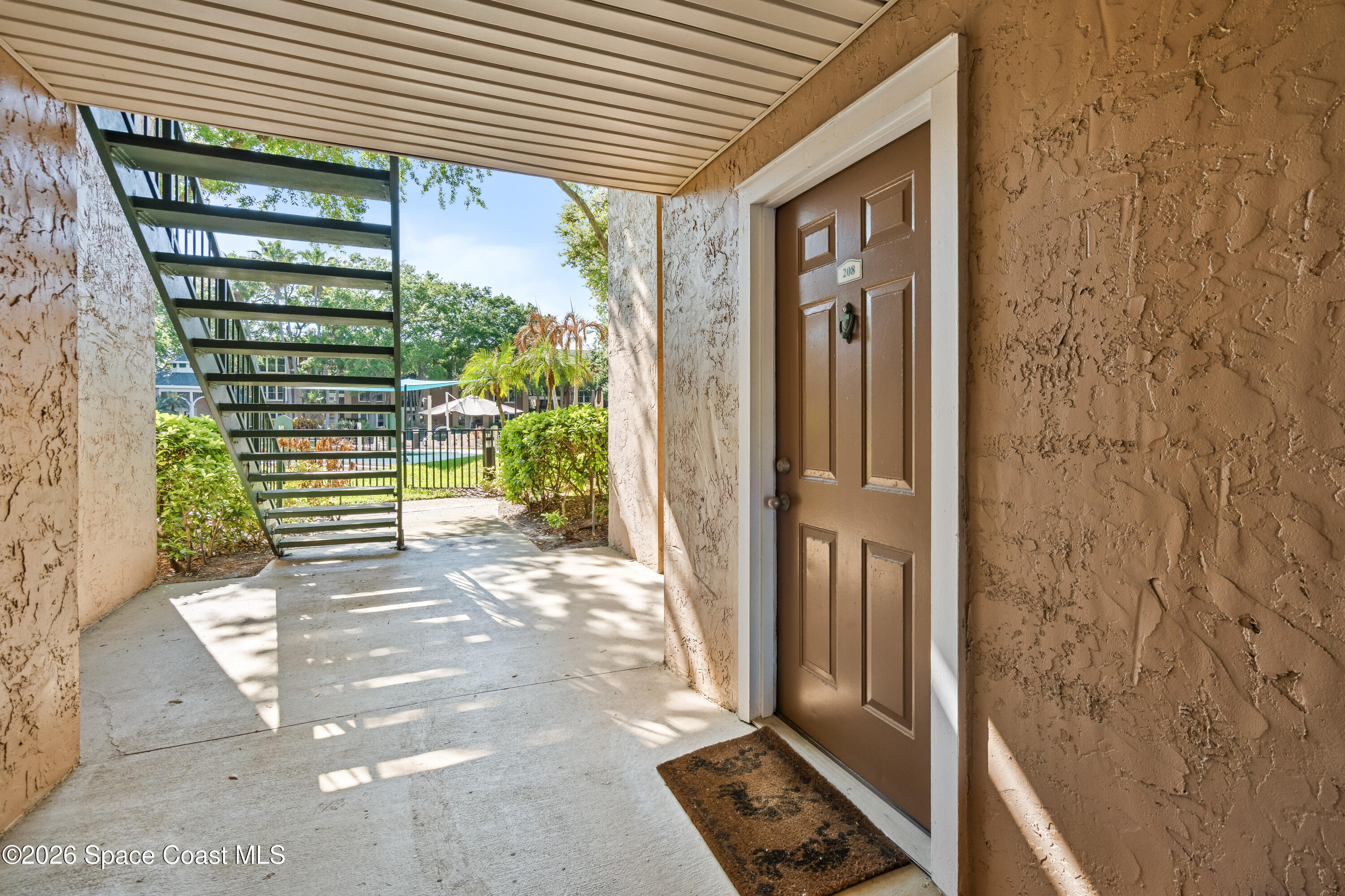 7667 North Wickham Road, Unit 208 Melbourne, FL 32940 - Photo 23 of 33 a view of a front door and bedroom