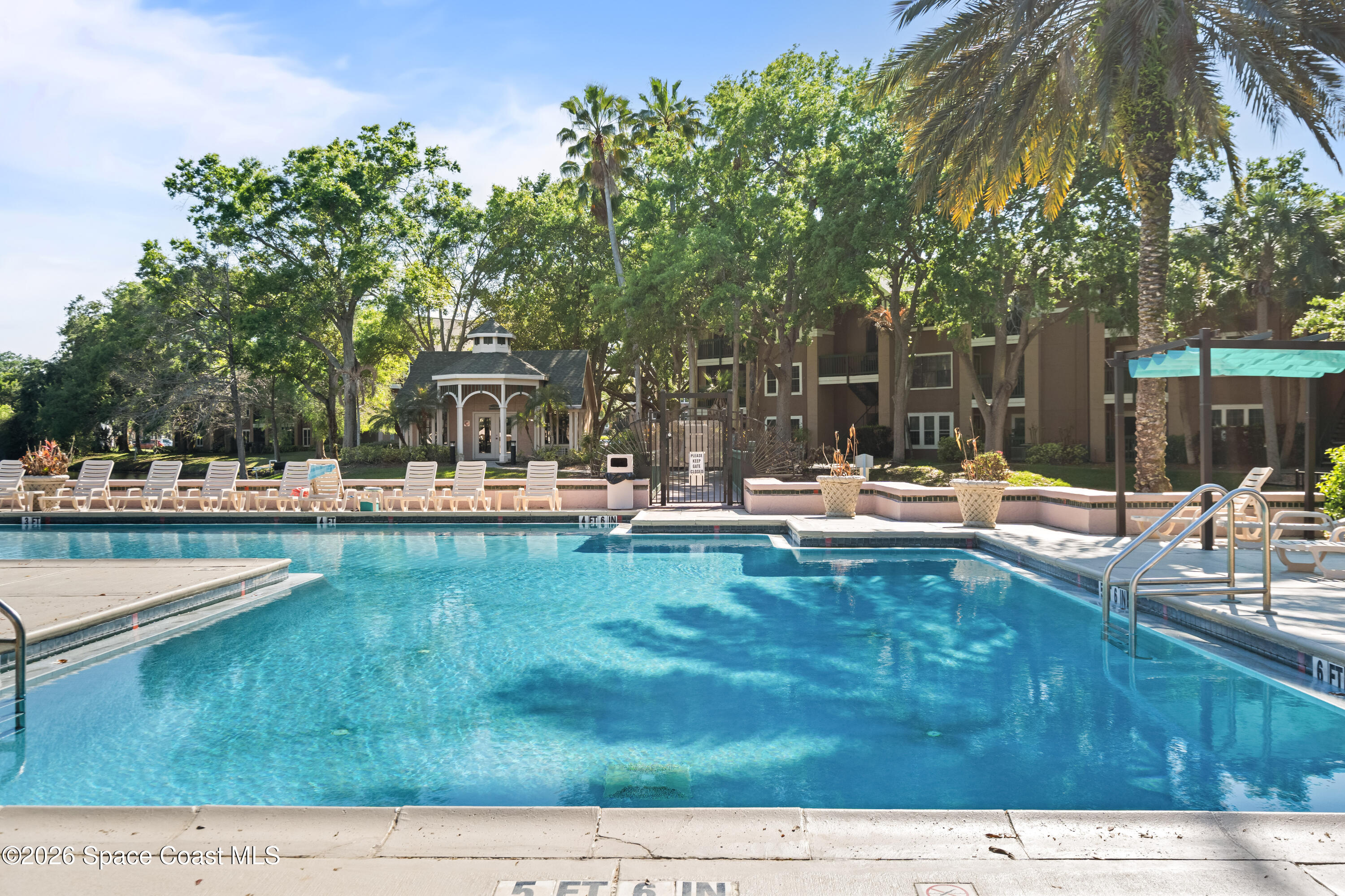7667 North Wickham Road, Unit 208 Melbourne, FL 32940 - Photo 24 of 33 a swimming pool with outdoor seating and yard