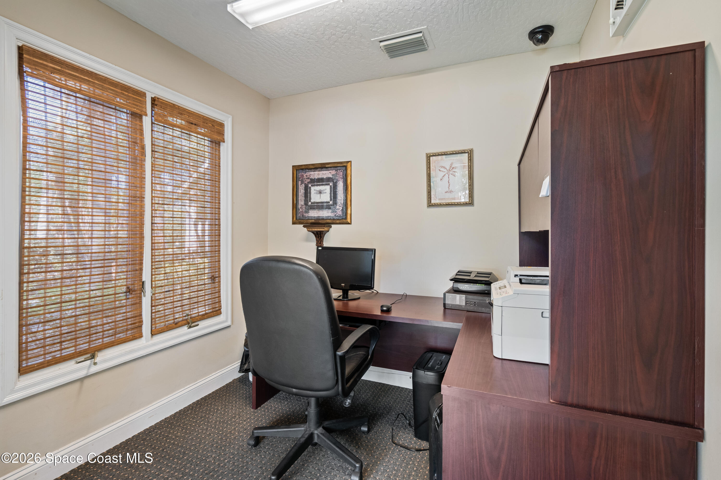 7667 North Wickham Road, Unit 208 Melbourne, FL 32940 - Photo 26 of 33 a view of a workspace with furniture and a window