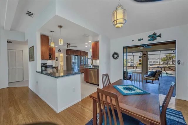 a large kitchen with kitchen island granite countertop a large counter top stainless steel appliances and cabinets