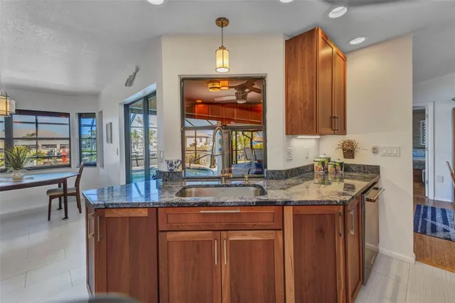 a kitchen with stainless steel appliances granite countertop a refrigerator and a sink