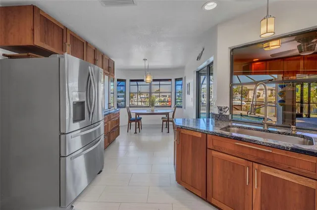 a dining room with furniture a chandelier and window