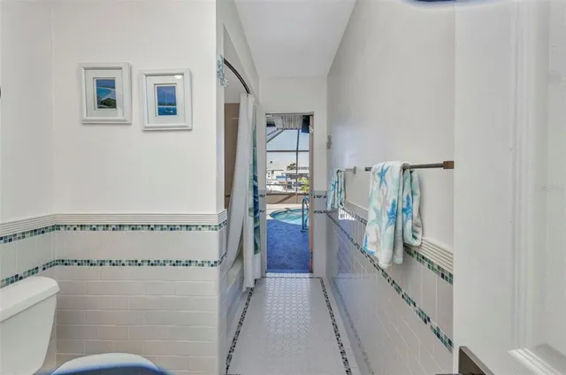 a dining room with furniture a chandelier and wooden floor