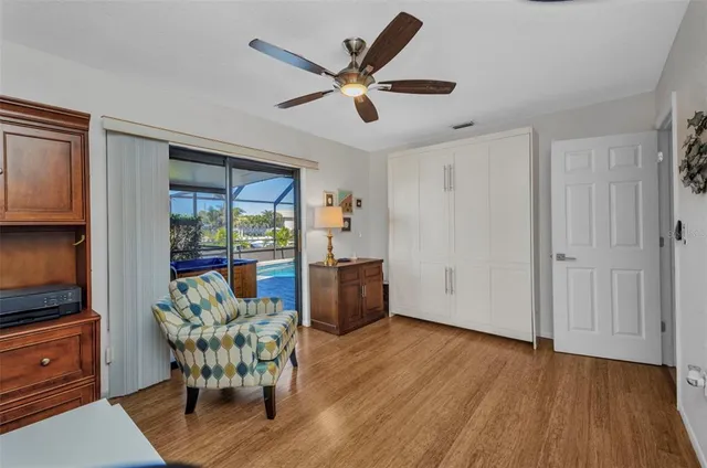a living room with furniture and a floor to ceiling window