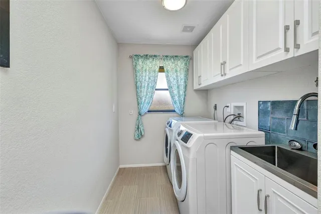 a dining room with furniture a chandelier and wooden floor