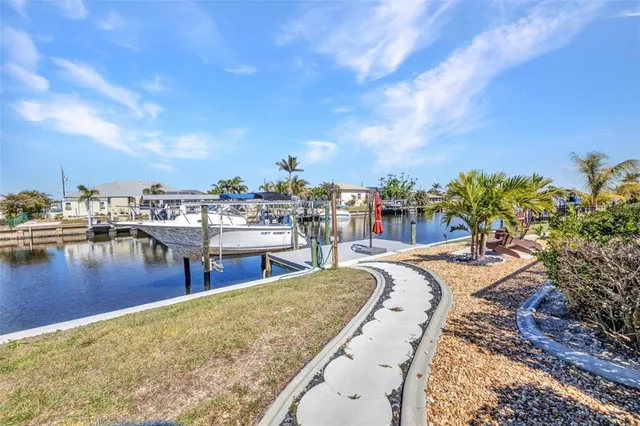 a view of a lake with boats and palm trees