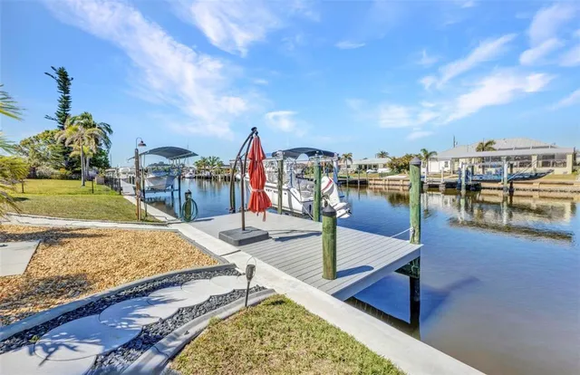 a front view of a house with a garden and yard