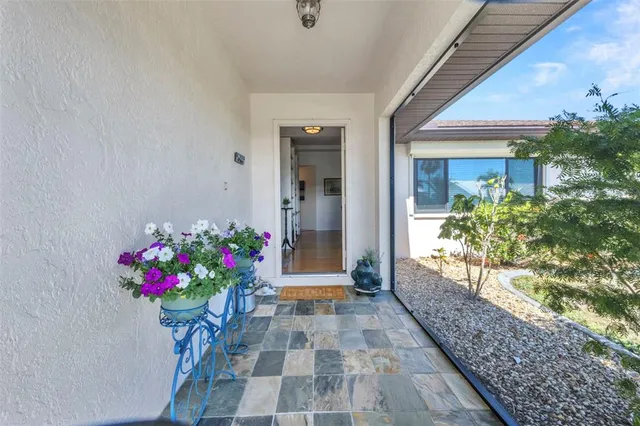 a flower garden is sitting in front of a house