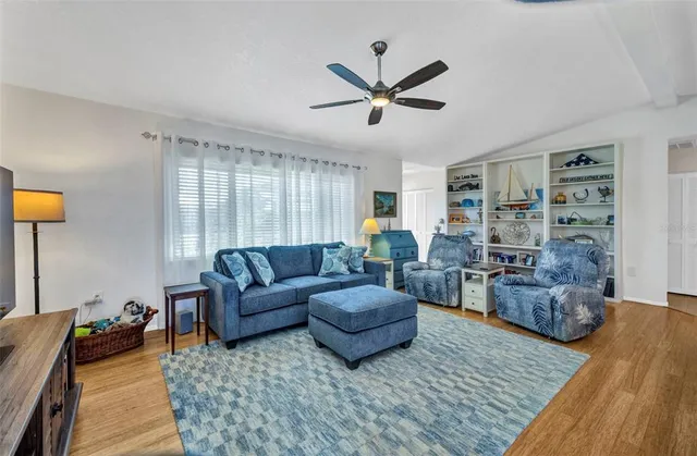 a living room with furniture and a wooden floor