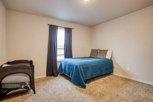 a bedroom with a bed and a chair