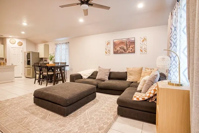 a living room with furniture and kitchen view