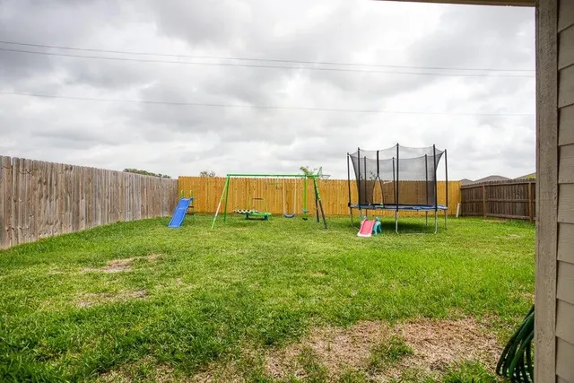 a view of a backyard with swimming pool