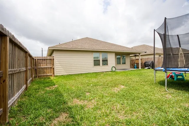 a view of a house with a backyard