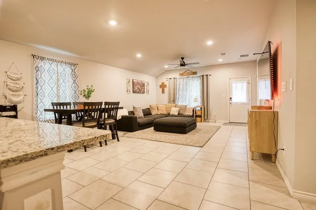 a living room with furniture and a flat screen tv