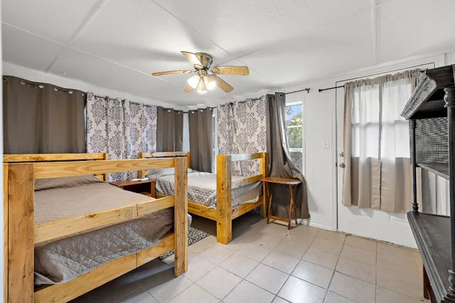 a bedroom with furniture and a chandelier