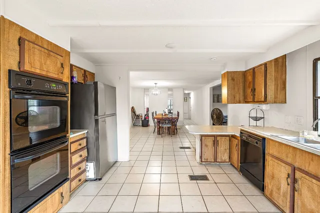 a kitchen with stainless steel appliances a refrigerator sink and cabinets