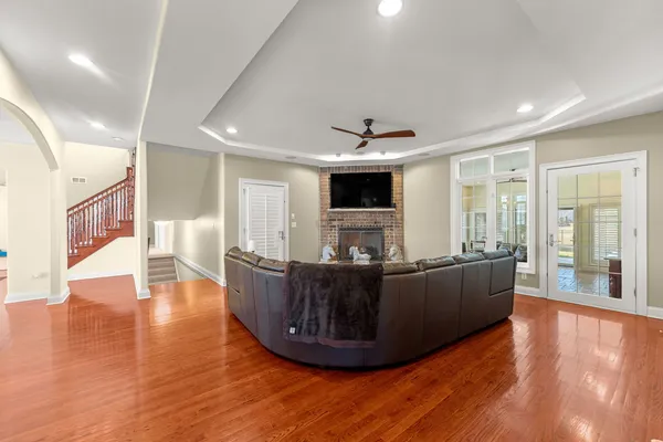 a living room with furniture a flat screen tv and a fireplace