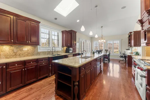 a living room with stainless steel appliances furniture a fireplace and a flat screen tv