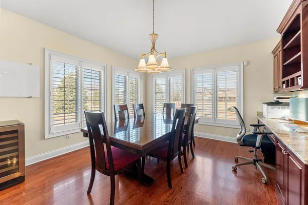 a view of a dining room with furniture and chandelier