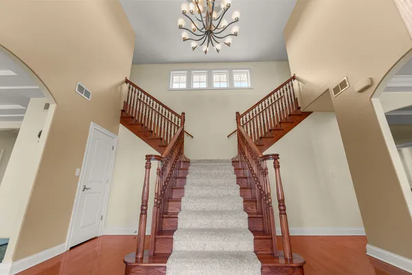 a spacious bathroom with a double vanity sink a large mirror and a shower