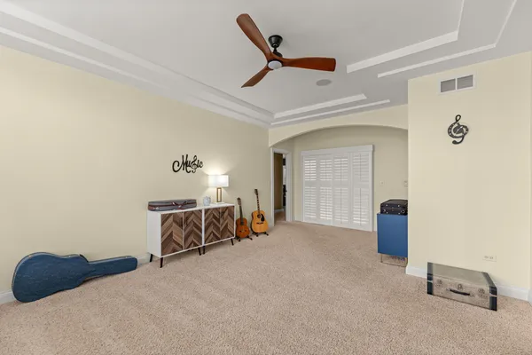 a spacious bedroom with a bed and a window