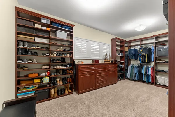 a bedroom with a large bed and a night stand