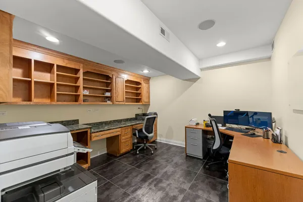 a kitchen with stainless steel appliances granite countertop a refrigerator a sink and white cabinets
