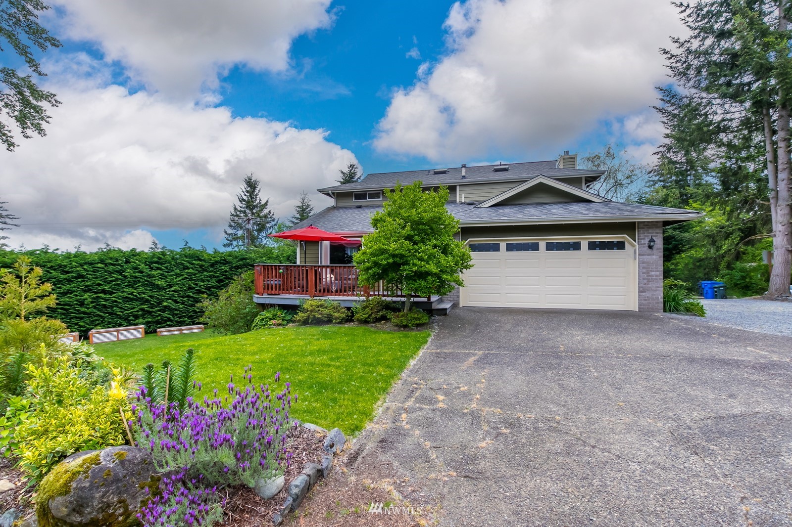 7413 Vandermark Road East Bonney Lake, WA 98391 - Photo 1 of 39 a front view of a house with a yard and fountain