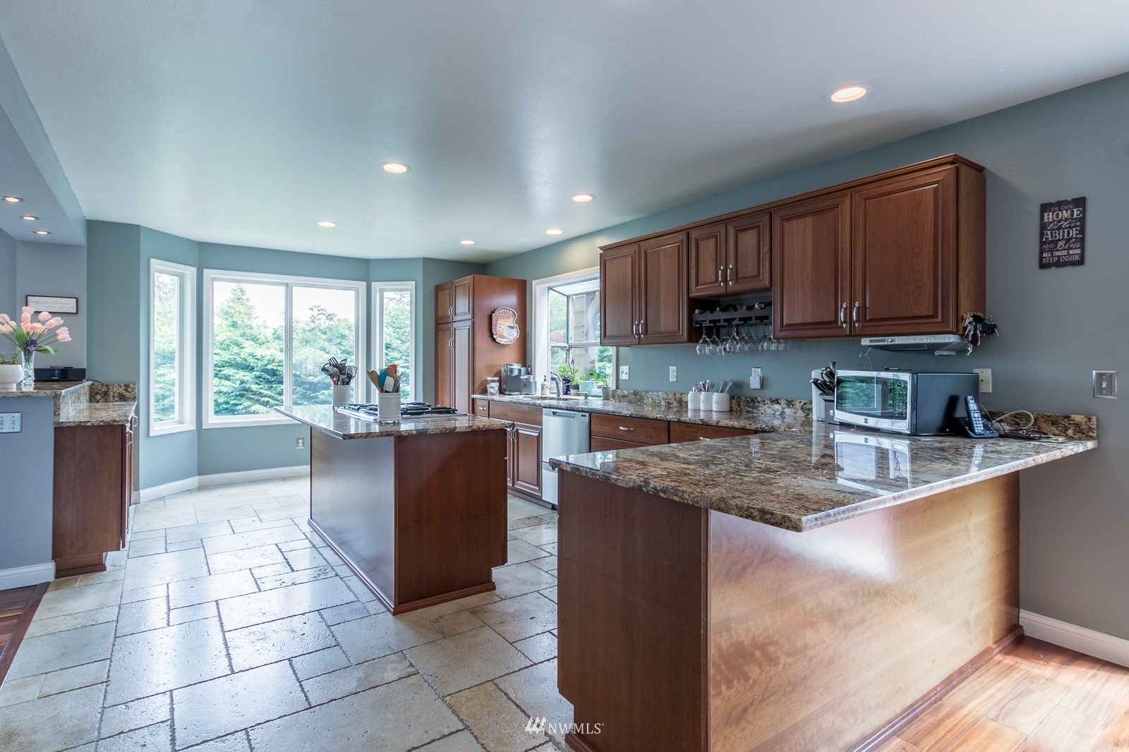 7413 Vandermark Road East Bonney Lake, WA 98391 - Photo 11 of 39 a kitchen with stainless steel appliances granite countertop a stove a sink a microwave and a refrigerator