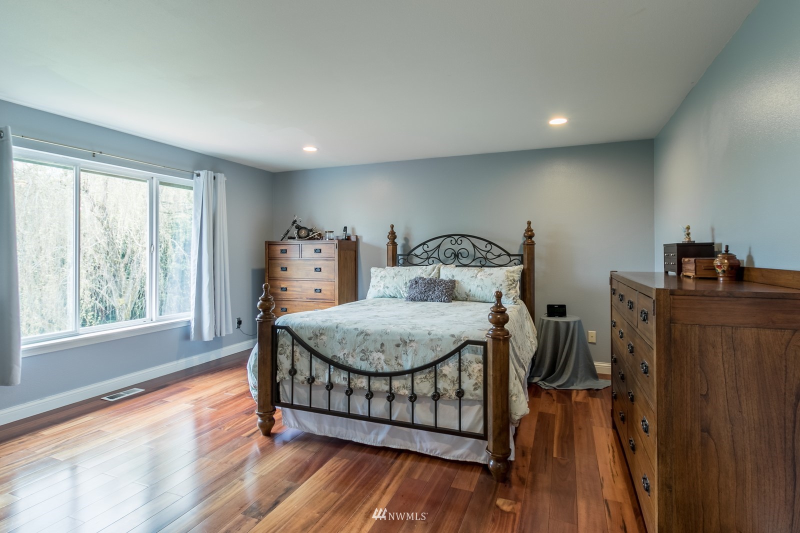 7413 Vandermark Road East Bonney Lake, WA 98391 - Photo 19 of 39 a bedroom with a bed and wooden floor