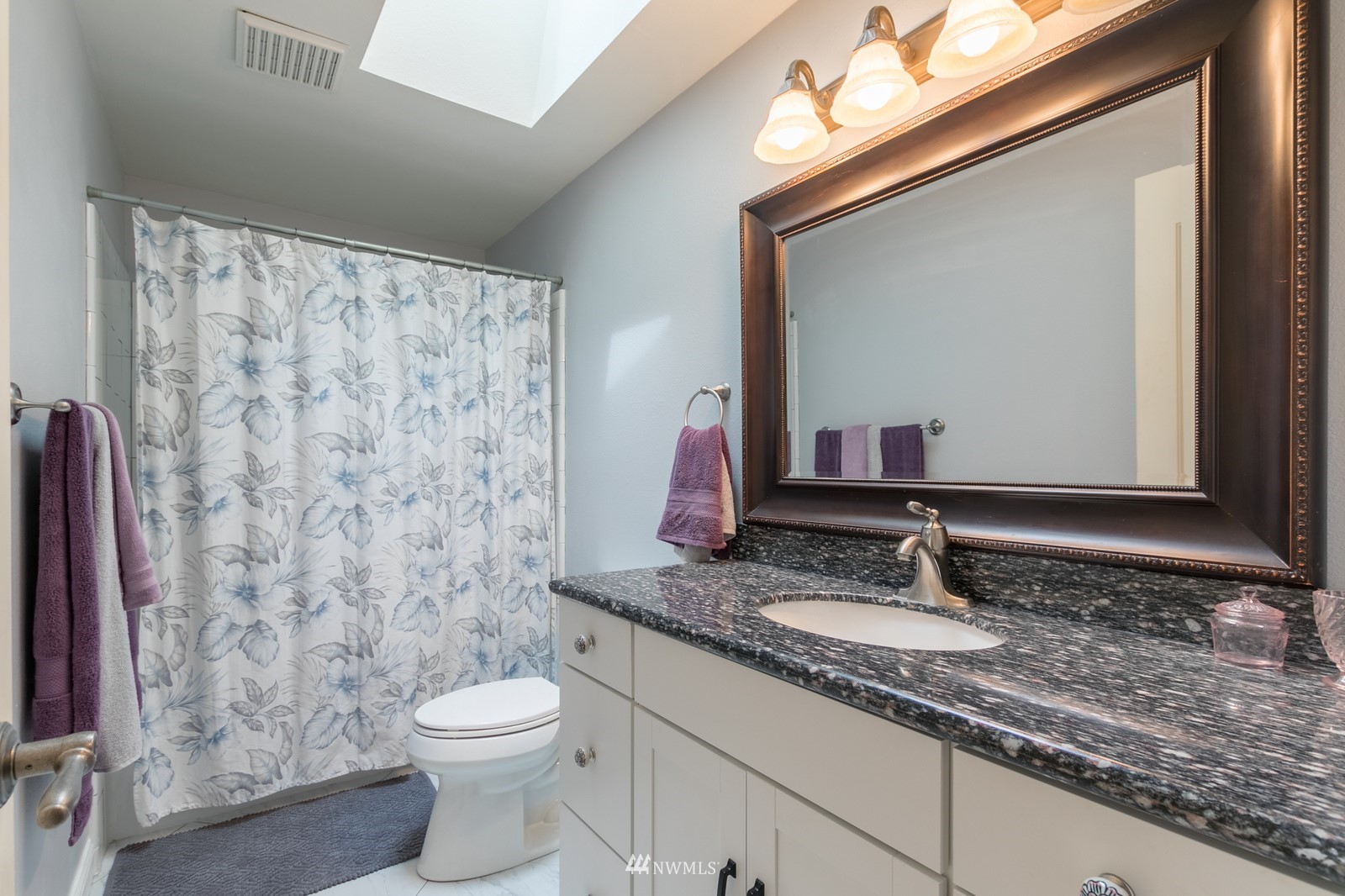 7413 Vandermark Road East Bonney Lake, WA 98391 - Photo 27 of 39 a bathroom with a granite countertop sink and a mirror