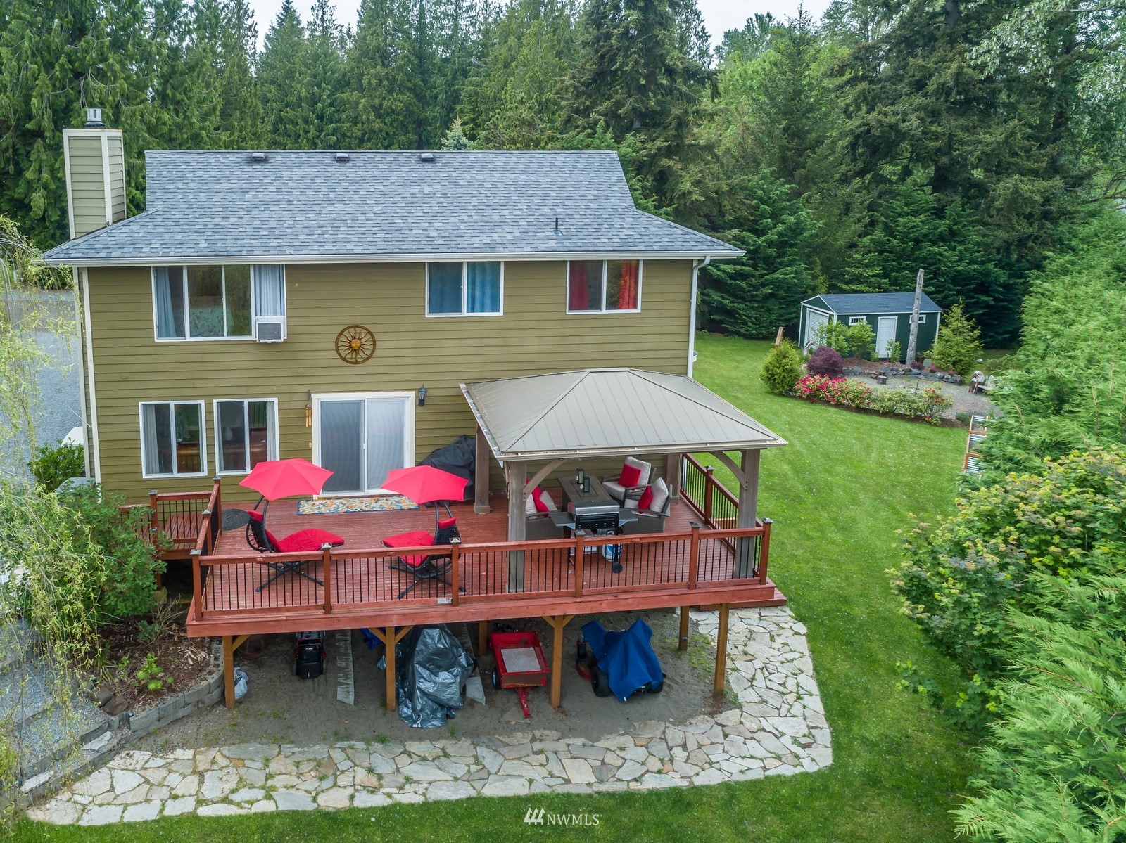 7413 Vandermark Road East Bonney Lake, WA 98391 - Photo 29 of 39 a view of a patio with table and chairs under an umbrella