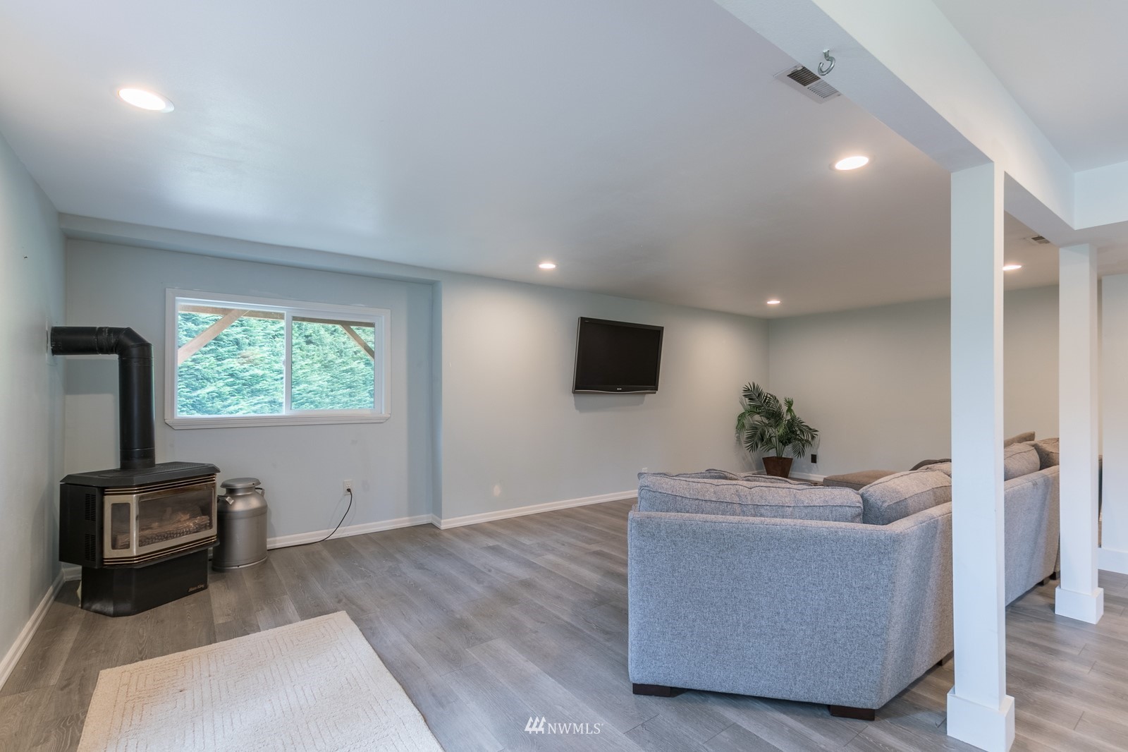 7413 Vandermark Road East Bonney Lake, WA 98391 - Photo 33 of 39 a living room with furniture and a flat screen tv