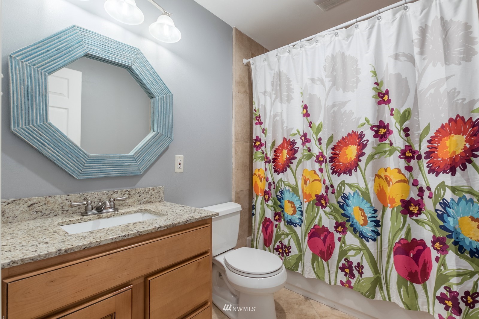 7413 Vandermark Road East Bonney Lake, WA 98391 - Photo 35 of 39 a bathroom with a toilet sink and mirror