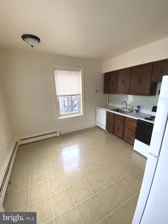 a view of kitchen with stainless steel appliances granite countertop a sink and cabinets