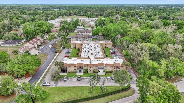 an aerial view of a house with a yard and lake view
