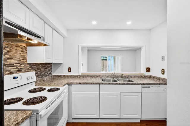 a kitchen white cabinets and white appliances