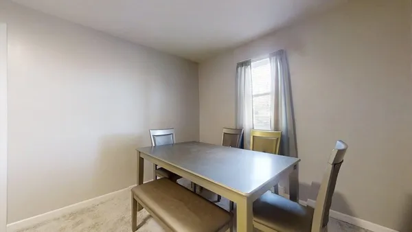 a view of a workspace with furniture and window