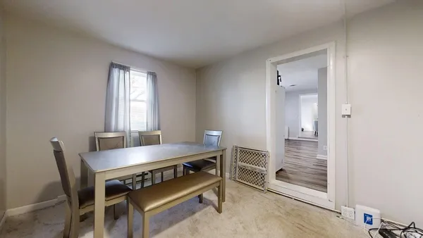 a view of a dining room with furniture and window