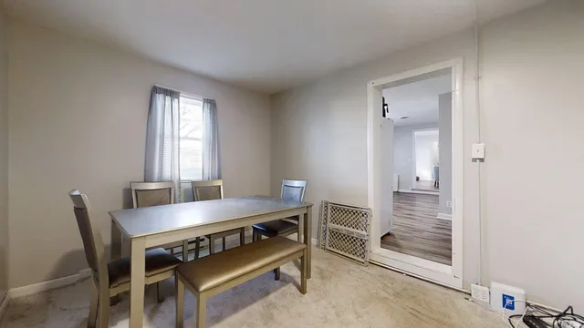 a view of a dining room with furniture and window