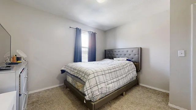 a bed sitting in a bedroom next to a window