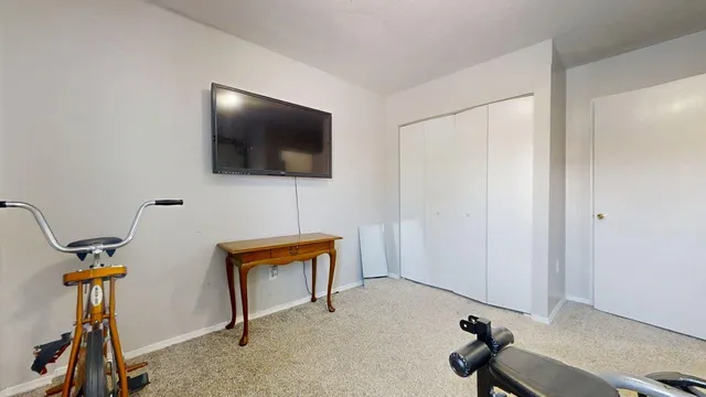 a view of a livingroom with furniture and a flat screen tv